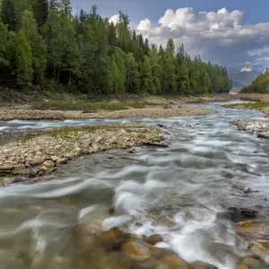 Doris Creek runs into Hungry Horse Reservoir with Flathead Range in background in