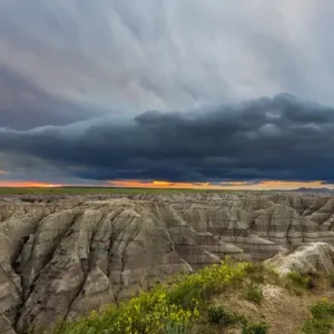 Dramatic storm cloud at sunrise in Badlands National Park, South Dakota, USA