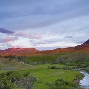 Elk Creek runs below Haystack Butte at first light near Augusta, Montana, USA
