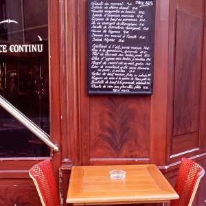 EU, France, Paris. Two chairs in front of a Parisian bistro