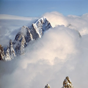 Europe, France, Chamonix. The jagged spires of Aiguilles du Midi capture the clouds
