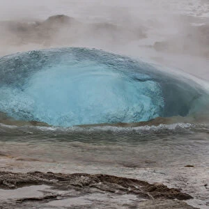 Europe, Iceland, Geysir Hot Springs. A Strokkur Geyser bubble just before it explodes