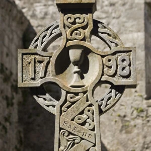 Europe, Ireland, County Mayo, Burrishoole Abbey. Stone Celtic cross dated 1798 within