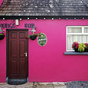 Europe, Ireland, Emly. Exterior of brightly painted pub. Credit as: Dennis Flaherty