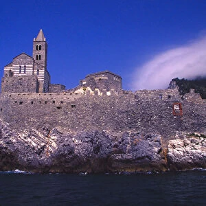 Europe, Italy, Gulf of Genoa. Church of St. Peter on cliff upon entering town of