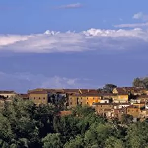 Europe, Italy, San Miniato. Beneath a wide, blue sky, the sienna tones of San Miniato spread