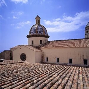 Europe, Italy, San Stefano. Roof tiles form a beautiful pattern on the church at