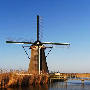 Europe; Netherlands; Kinderdijk; Windmills with Evening light along the Kinderdijk canal