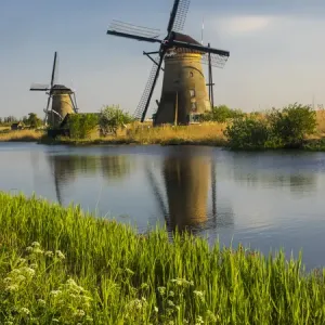Europe; Netherleands; Kinderdyk; Windmills with evening light along the canals of Kinderdijk Europe; Netherleands; Kinderdyk; Windmills with evening light along the canals of Kinderdijk