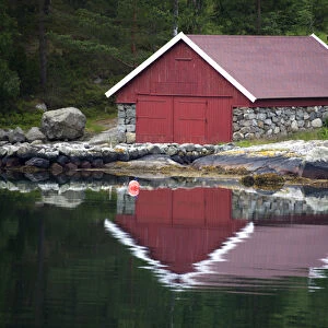 Europe, Norway, Stavanger. Boathouse and reflection on Lysefjord