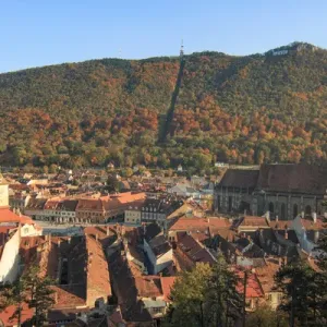 Europe, Romania, Brasov. City signage. Poarta Schei district. Looking out over forested park