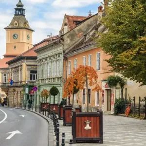 Europe, Romania, Brasov, Street scene from Council Square. Clock tower