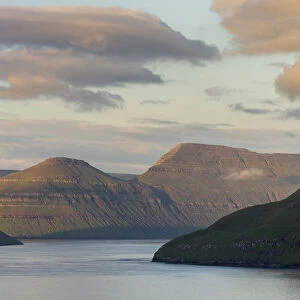 Fjord Fuglafjordur and Leirviksfjordur at sunset, in the background the mountains
