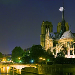 France, Paris. Full moon over Notre Dame Cathedral at night
