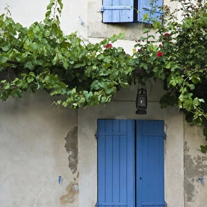 France, Provence, Lourmarin. Blue shutters cover a doorway to a home