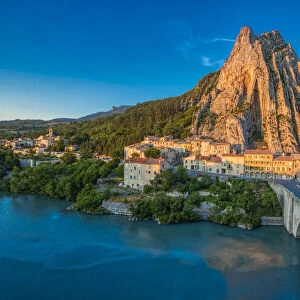 France, Provence, Sisteron. Mountain and bridge to town at sunset