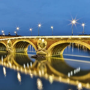 France, Toulouse. View of Pont Neuf and the Garonne River and reflections at sunset