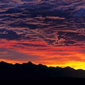 Germany, Bavaria, Alps. Sunset silhouettes the jagged peaks of the Bavarian Alps