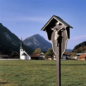 Germany, Bavaria. A roadside shrine marks the entrance to a village in Bavaria, Germany