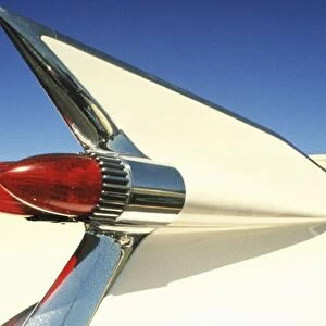 Graphic: Close-up of fin and taillight on classic car