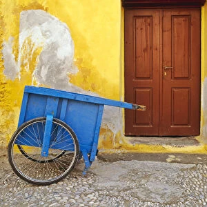 Greece, Rhodes. House with blue cart in front
