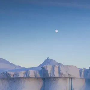 Greenland, Disko Bay, Ilulissat, floating ice at sunset with moonrise Greenland, Disko Bay, Ilulissat, floating ice at sunset with moonrise