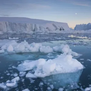 Greenland, Disko Bay, Ilulissat, floating ice at sunset with moonrise Greenland, Disko Bay, Ilulissat, floating ice at sunset with moonrise