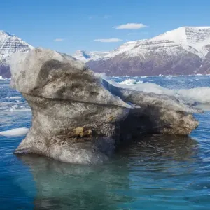 Greenland. Scoresby Sund. Gasefjord. Krogen. Dirty iceberg from the bottom of a glacier Greenland. Scoresby Sund. Gasefjord. Krogen. Dirty iceberg from the bottom of a glacier