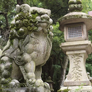 A guardian stone lion traditional stone lantern at the entrance to Kasuga-Taisha Shrine in Nara