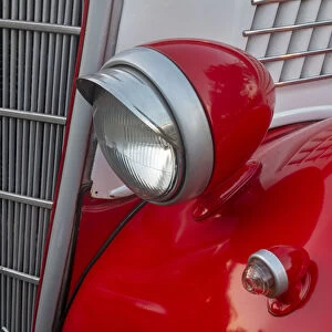 Detail of head lamp on red classic American Ford in Habana, Havana, Cuba