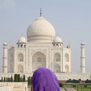 Hindu woman with colorful sari veil in the quiet peaceful Taj Mahal one of the wonders