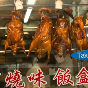 Hong Kong China Peking duck hanging in window Kowloon Woosung Street with reflections