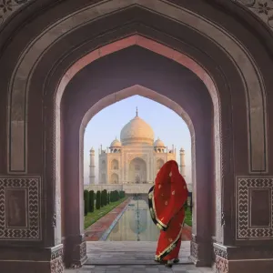 India, Agra, Taj Mahal. Composite of woman in archway facing mausoleum