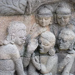 Indonesia, Java, Borobudur. Largest Buddhist monument in the world. UNESCO. Detail of carved stone figures in the hidden foot