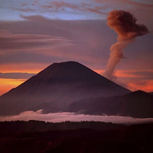 Indonesia. Mt. Semeru emits a plume of smoke moved by strong winds at sunrise. Credit as