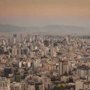 Iran, Tehran, elevated city skyline from the Roof of Iran Park, dusk