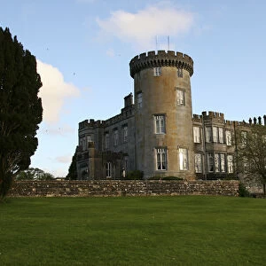 In Ireland, the Dromoland Castle turret grounds and green lawn with blue sky white clouds