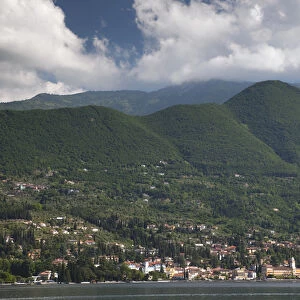 ITALY, Brescia Province, Gardone Riviera. Distant town view with mountains