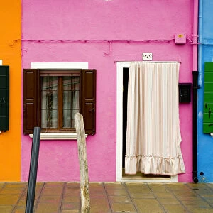 Italy, Burano. Colorful house windows and walls