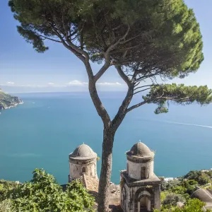 Italy, Campania, Ravello. View of the Amalfi Coast and the towers of Villa Rufolo in the hilltop town of Ravello
