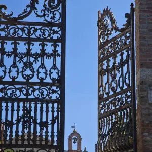 Italy, Tuscany, Montepulciano. The wrought iron gate leading to the cemetery near the Church of San Biaggio Italy, Tuscany, Montepulciano. The wrought iron gate leading to the cemetery near the Church of San Biaggio