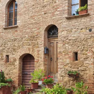 Italy, Tuscany, Pienza. Flower pots and potted plants decorate a narrow street in a Tuscany village Italy, Tuscany, Pienza. Flower pots and potted plants decorate a narrow street in a Tuscany village