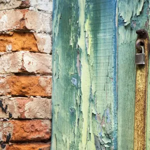 Italy, Venice, Burano Island. Patterns of peeling paint on old wooden doors