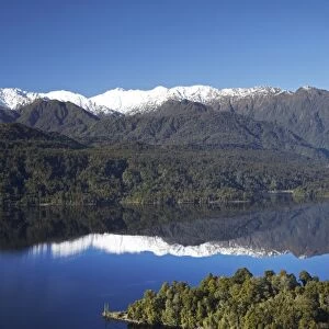Kayakers, Lake Mapourika, and Southern Alps, West Coast, South Island, New Zealand