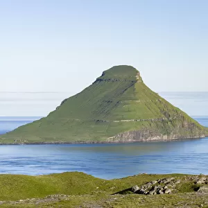 Koltur island at sunrise, the island Vagar in the background The island Streymoy