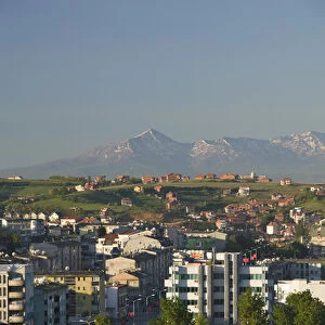 KOSOVO, Prishtina. Downtown Prishtina and the Albanian Mountains to the South / Morning