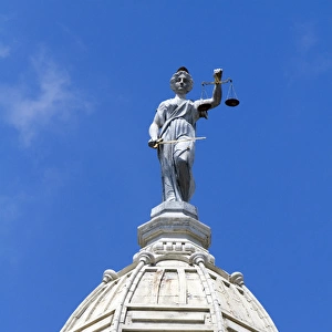Lady Justice depicted with a sword and scales atop the Ionia County Courthouse in Ionia