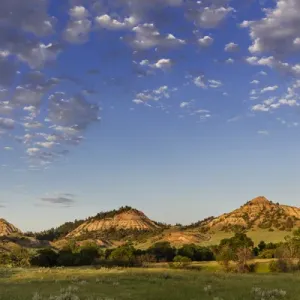Late day light on badlands and ranch pastures near Miles City, Montana, USA