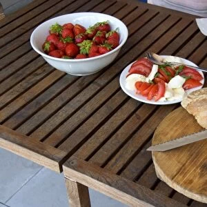 Light lunch of strawberries, tomato, cheese, and bread in Switzerland