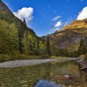McDonald Creek in autumn with Garden Wall in Glacier National Park, Montana, USA